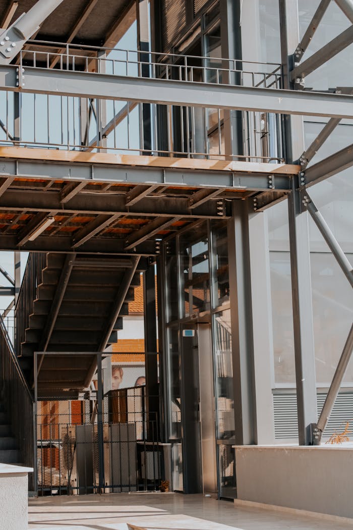 Contemporary multi-level construction with steel stairs and glass walls, ideal for urban architecture themes.